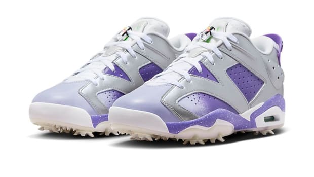 Side view of purple and grey Air Jordan golf shoes.